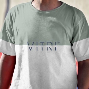 man with two-color tee shirt "VITRI" branding centered on shirt