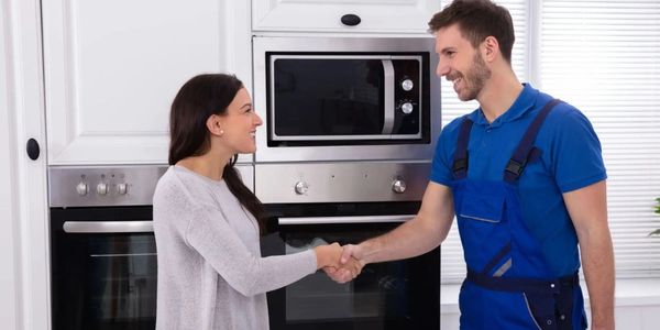 VL Appliance technician handshake with homeowner, trusted Winnipeg appliance repair & Smart Home. 