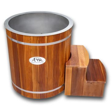 Wooden barrel sauna with attached step stool.