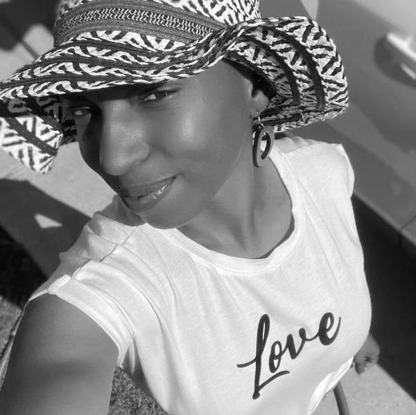 A darling little lady in a paper hat and a tee that reads "love"