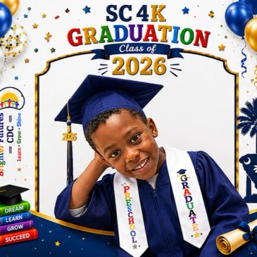 Young boy in graduation gown smiling.