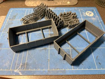 Parts of a model train or vehicle being assembled.