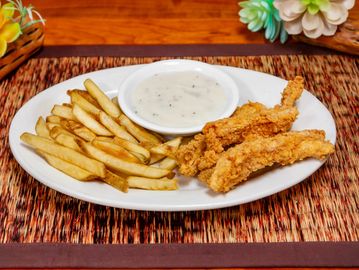 Plate of fried chicken tenders, fries, and white gravy.