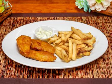 Fried fish with French fries and tartar sauce on a white plate.