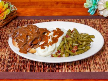 Meatloaf Roast Beef with mashed potatoes and green beans.