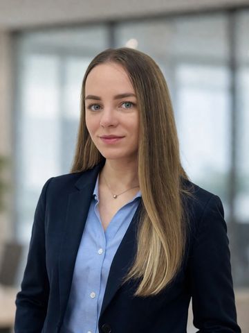 Professional woman in business attire with long straight hair.