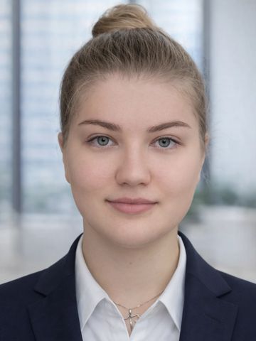 Professional young woman in business attire with a neat bun hairstyle.