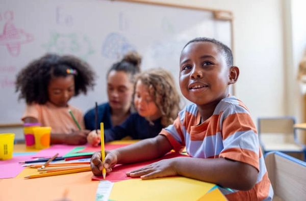 a little boy with a pencil in his hand 
