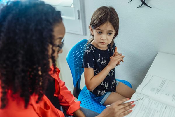 a teacher teaching a girl 