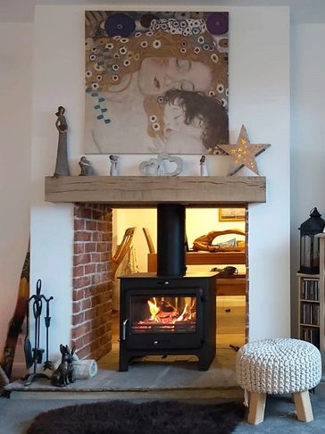 A double sided wood burning stove including a chimney system and beam stove installation Oxfordshire