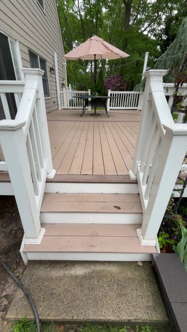Freshly cleaned back deck and entry stairs in Toms River, NJ — expert pressure washing removed dirt and mildew, enhancing curb appeal and safety.