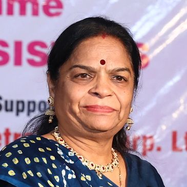 Portrait of a middle-aged woman in traditional attire with jewelry.