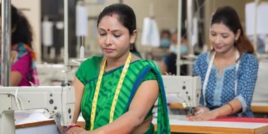 Women working on sewing machines in a textile factory.