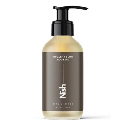 Bottle of Nish Opulent Glow Body Oil with pump dispenser.