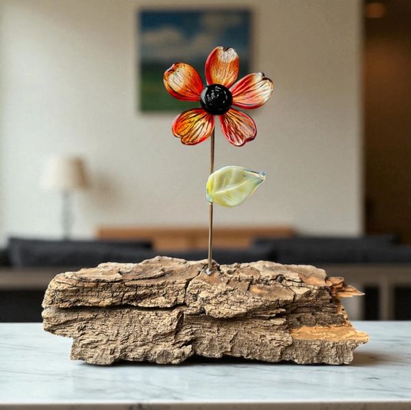 Clear and red glass flower on wood