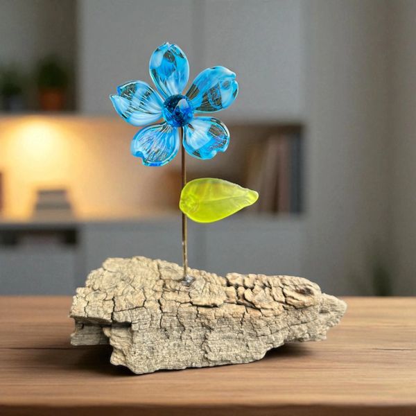 Blue and white glass flower on wood
