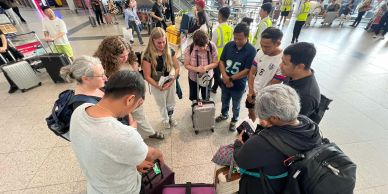 Group of travelers gathered at an airport.