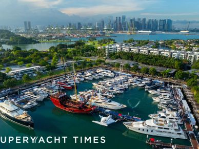 Aerial view of a marina filled with boats and yachts under a cloudy sky.