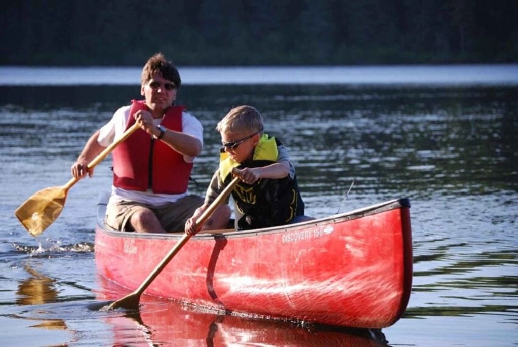 A father and son enjoying a quiet moment on the lake.