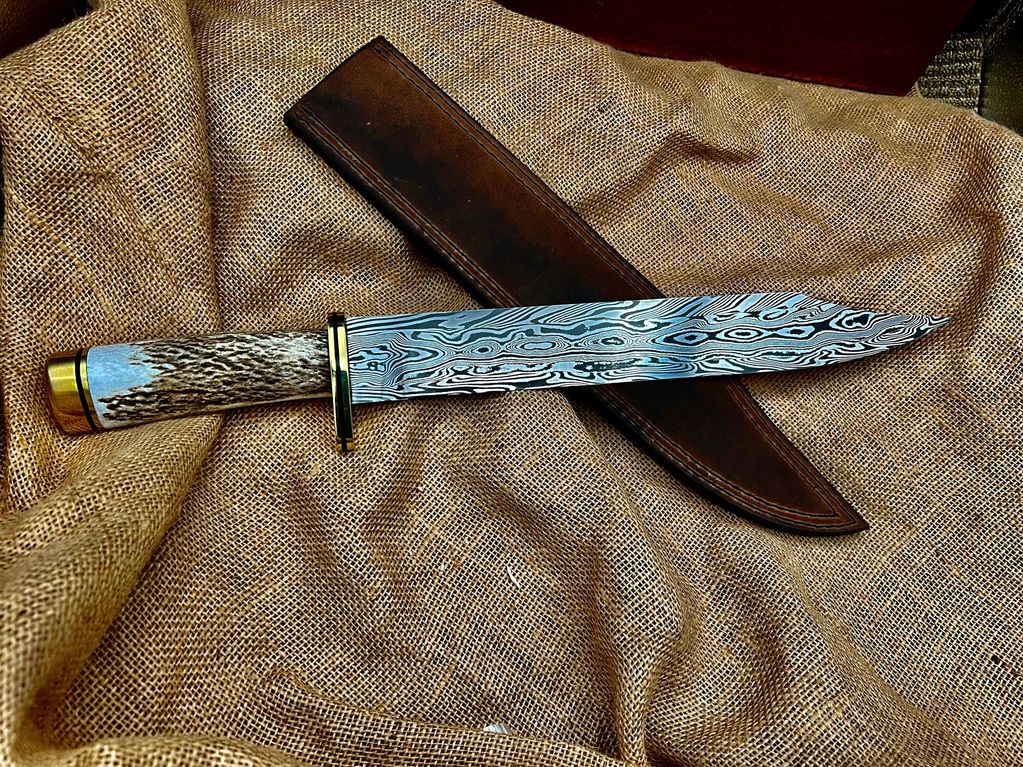 1095/15N20 Bowie. Twisted bars around a chevron pattern core bar. Brass, G10, and Elk Handle
