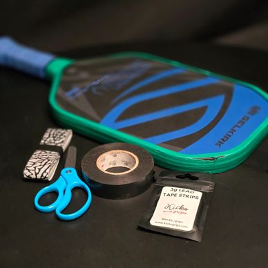 photo of PickleVend's MacGyver pickleball paddle maintenance kit with overgrip, scissors, tape