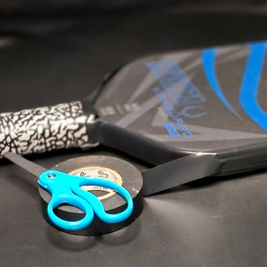 photo of edge guard tape being installed on a pickleball paddle for protection