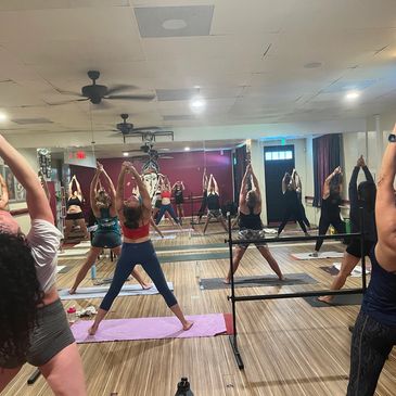 A Group of People Doing Yoga in a Room