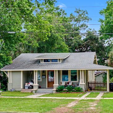 Cozy bungalow house surrounded by greenery.