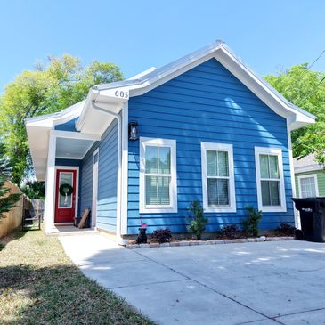 Blue house with red door and white trim.