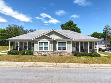 Single-story house with gray roof and stone accents.
