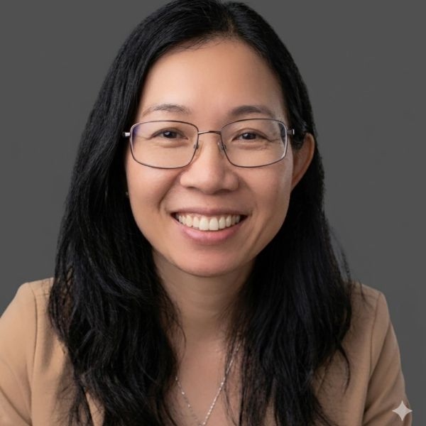 Smiling woman with glasses and long black hair.