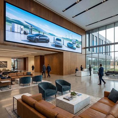 Corporate or commercial lobby entrance with large LED video display. Tall ceilings, luxury furniture