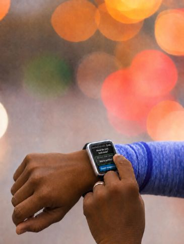 Person checking messages on a smartwatch.