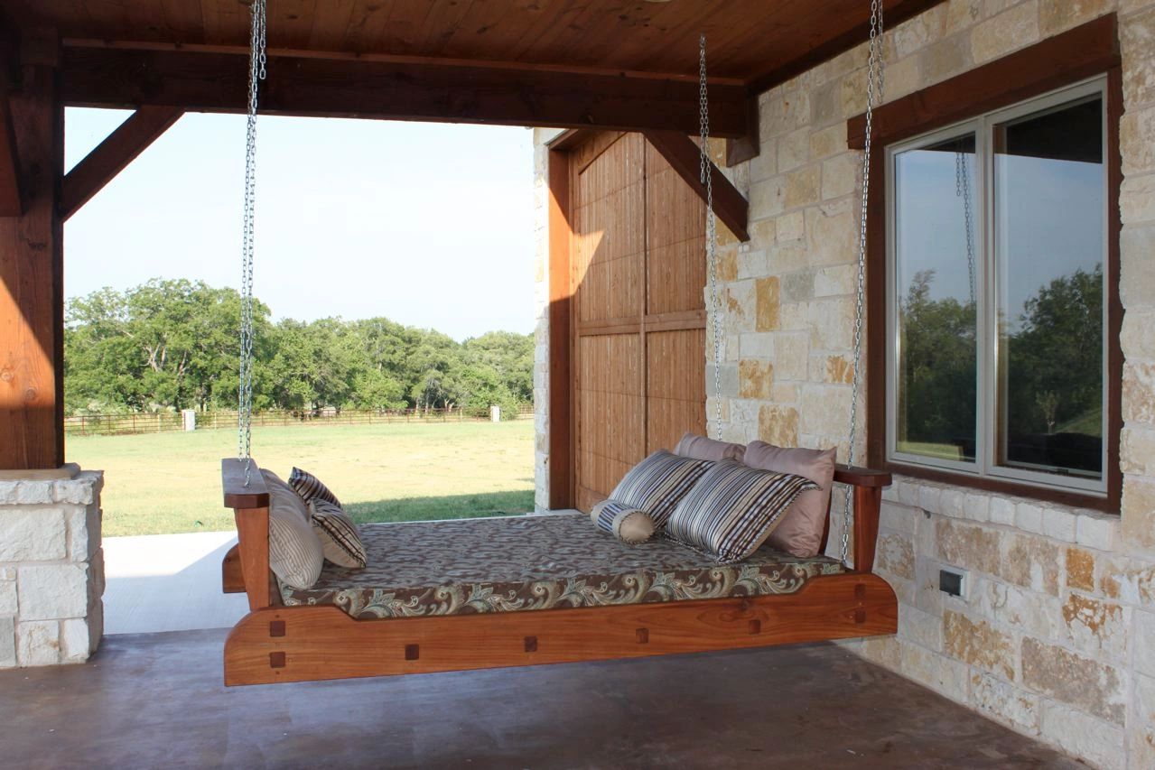 SwingBed hanging in a stone and timber outdoor living space