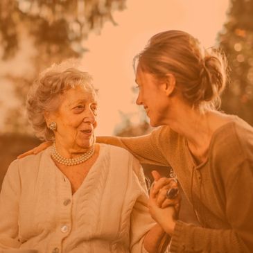 An elderly woman having a conversation with a middle aged woman