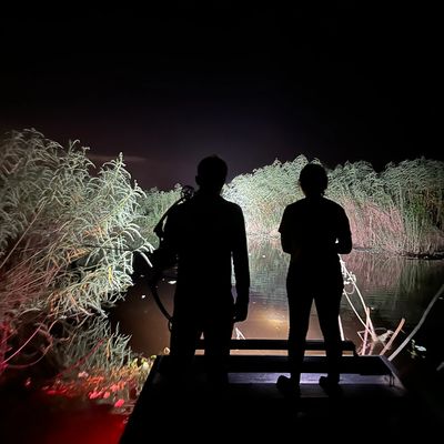 Couple bowfishing in St Johns River at night 