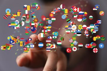 Fingers interacting with floating country flag icons.