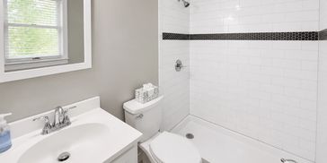 Bathroom remodeling with tiled shower, vanity, fixtures and updated finishes