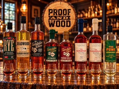 A lineup of whiskey bottles on a bar with a wooden sign.