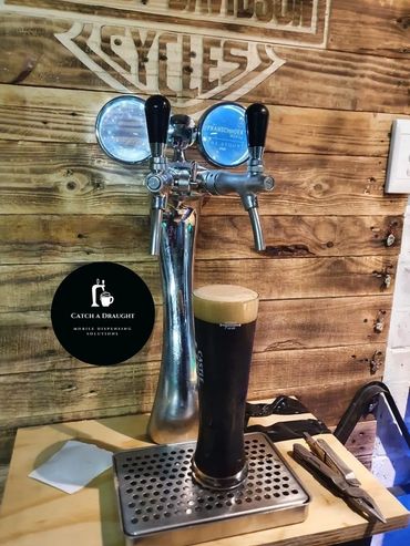 Beer dispenser tower on bar counter top with drip tray and under counter flash cooler
