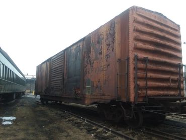 The ACY (Akron, Canton & Youngstown) boxcar sits in storage. The car is in need of bodywork and repa