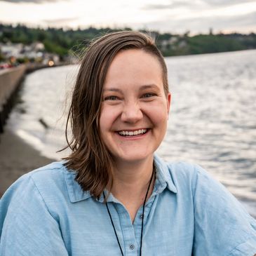 Midwife Lizz smiles at the beach in a photo by Instinctive Birth and Beyond