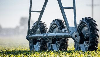 artistic photo of drive wheels on valley structure, water droplet overlay, green crop