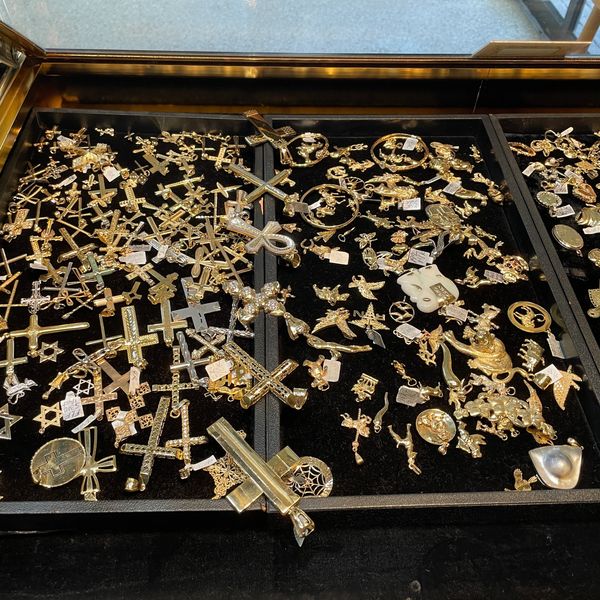 Cases filled with gold pendants at Oscar’s Estate Jewelry.