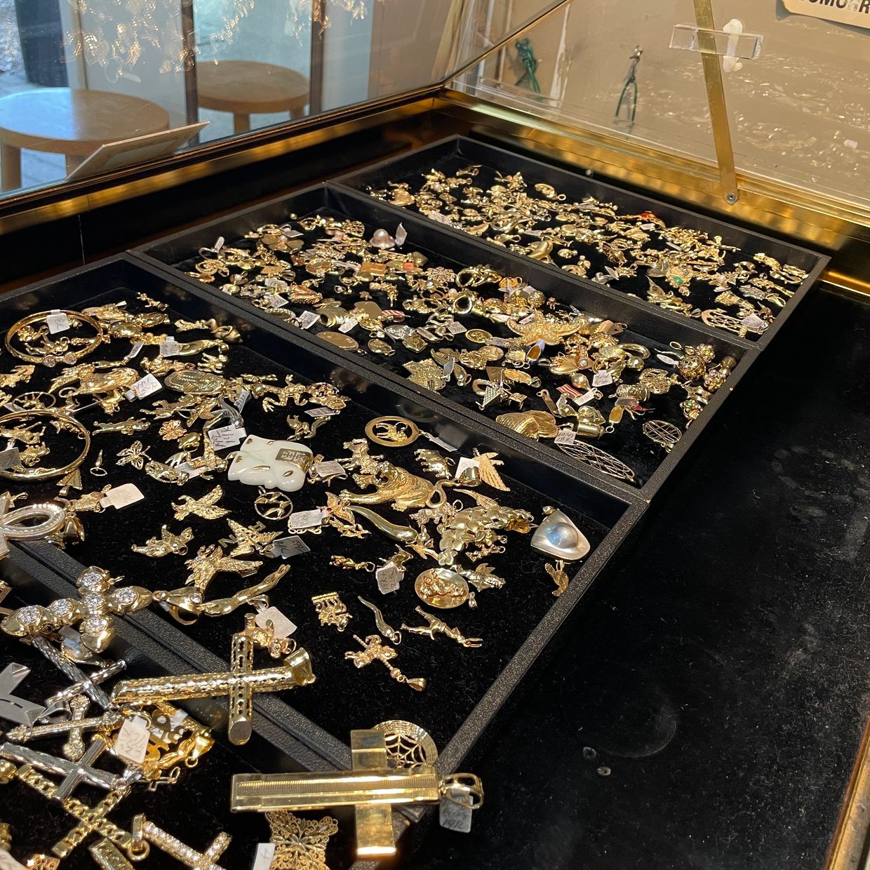 Variety of gold pendants displayed at Oscar’s Estate Jewelry.