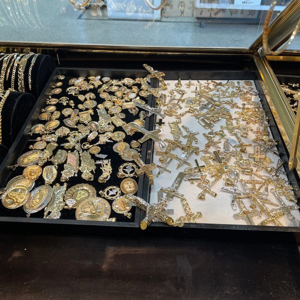 Cases filled with gold pendants at Oscar’s Estate Jewelry.