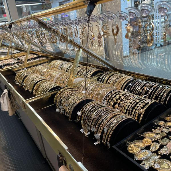 Gold bracelets displayed in a case at Oscar’s Estate Jewelry.