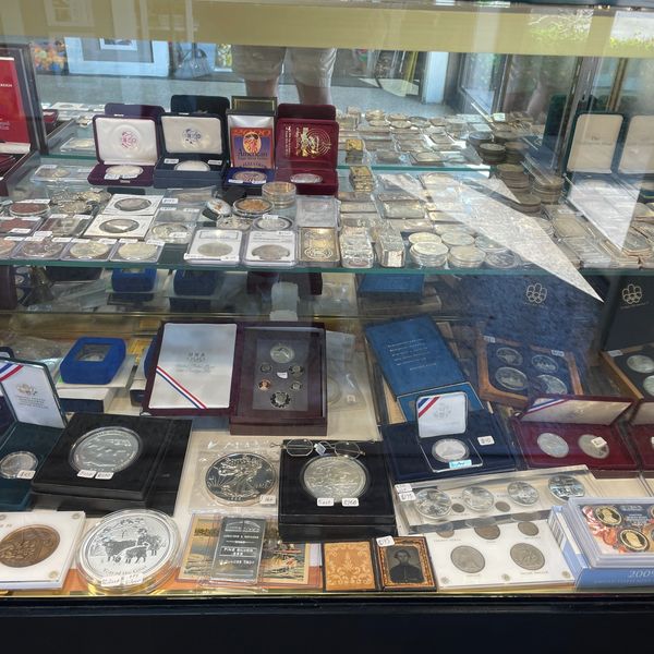 Collection of collectible silver coins at Oscar’s Estate Jewelry.