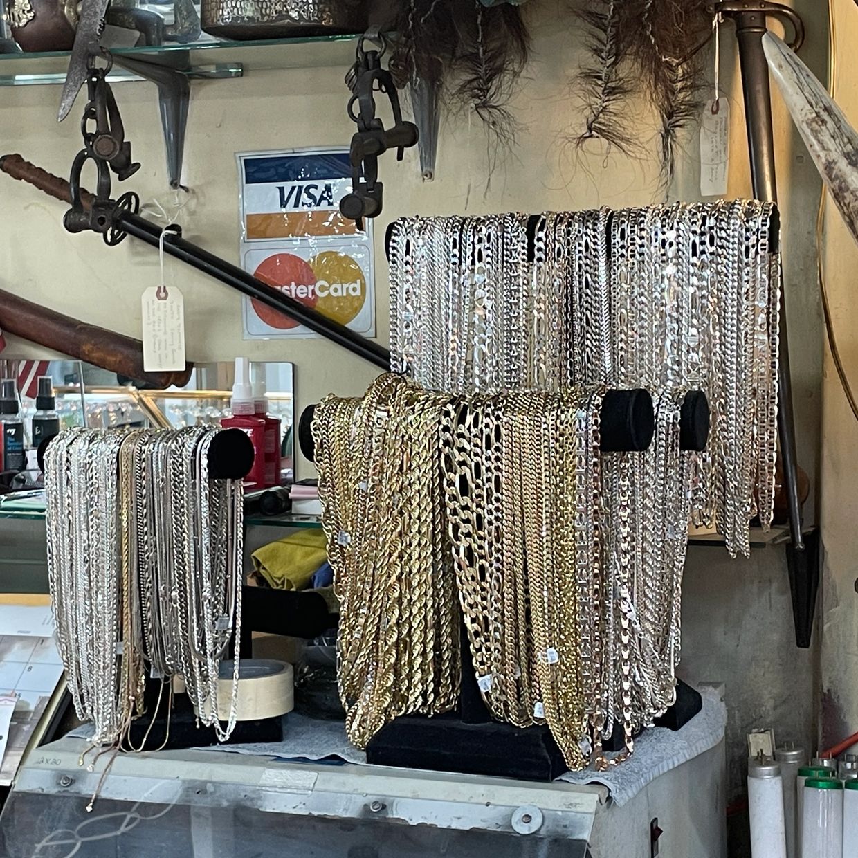 Many gold and silver Necklaces displayed at Oscar’s Estate Jewelry.
