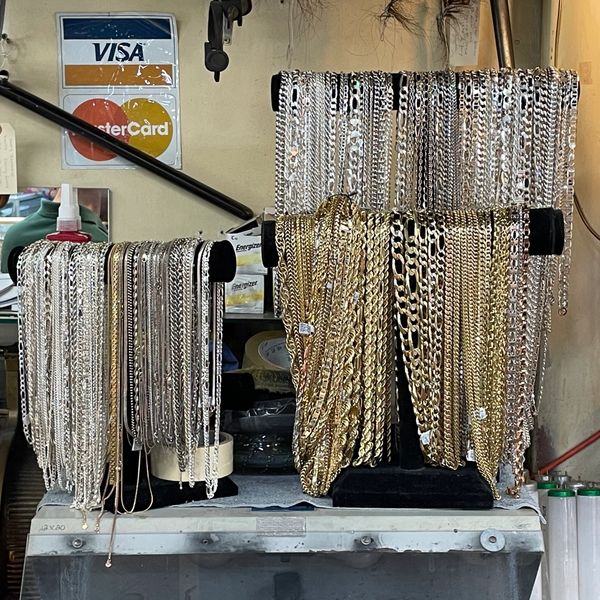 Many gold and silver necklaces displayed at Oscar’s Estate Jewelry.